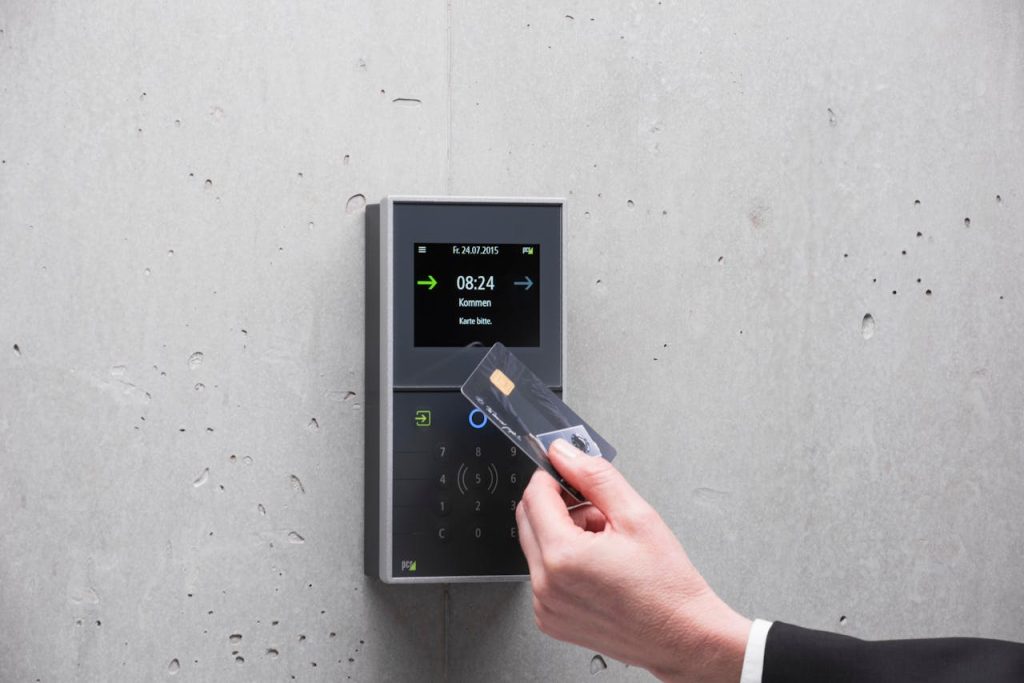 pexels photo 13657444 A businessman uses a secure card reader access system against a concrete wall.