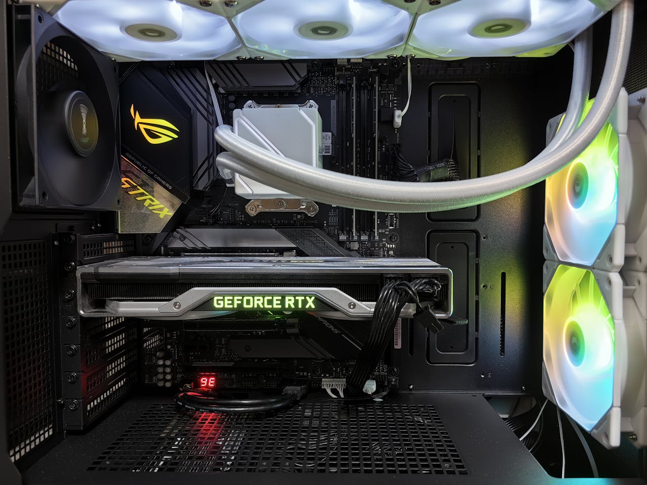 The Art of Drawing Readers In: Your attractive post title goes here Detailed view of a gaming PC build featuring a GeForce RTX graphics card and RGB lighting in a sleek black case.