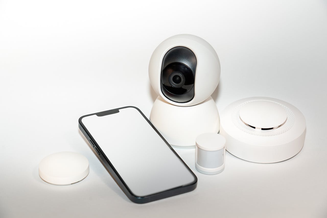 Home Collection of smart home security gadgets with a smartphone display.